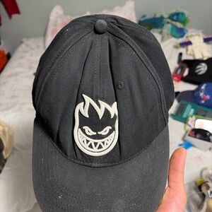 Black Snapback Hat with Flame Face Logo – Streetwear Skate Style.